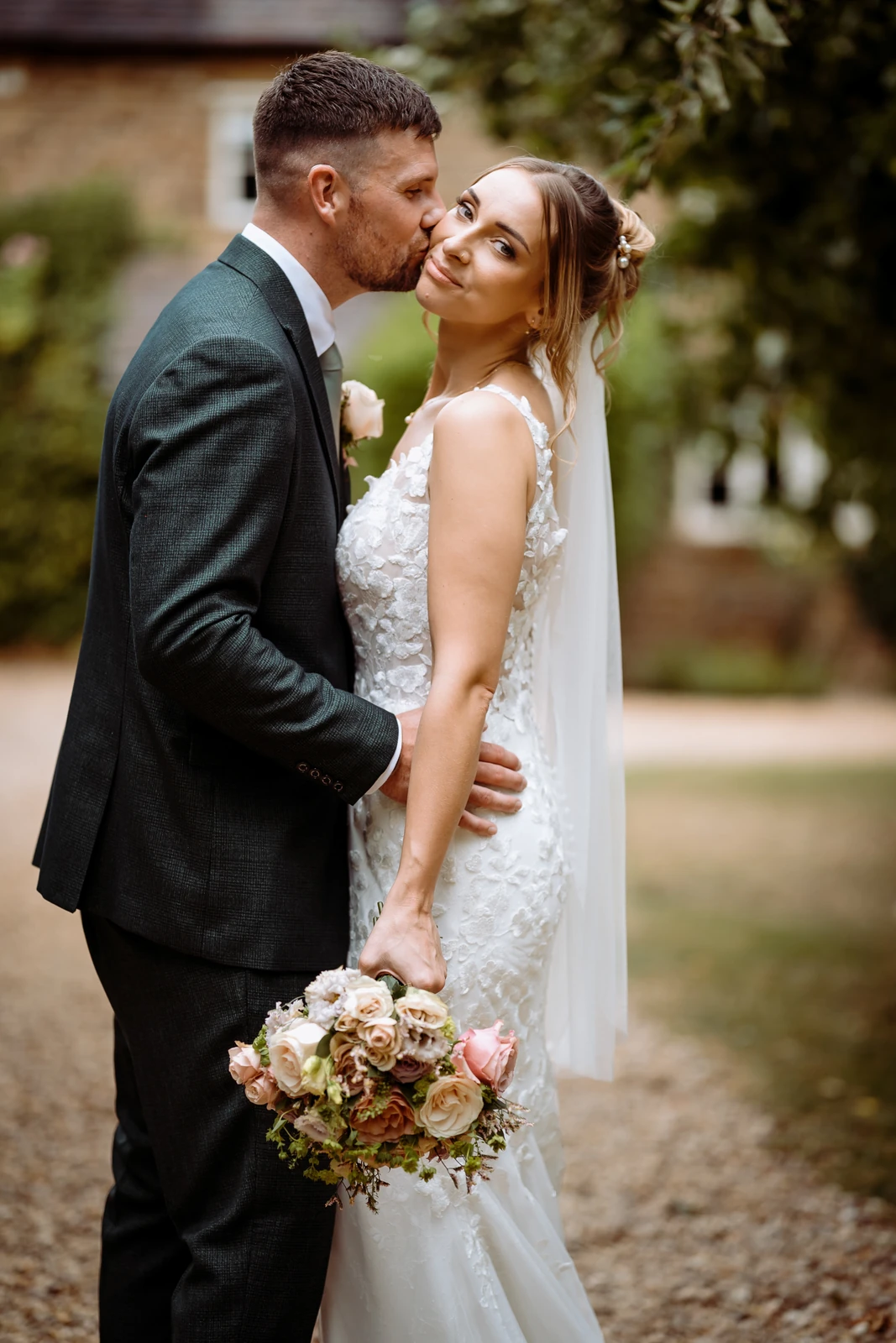 beautiful couple posing with flowers northampton wedding photographer