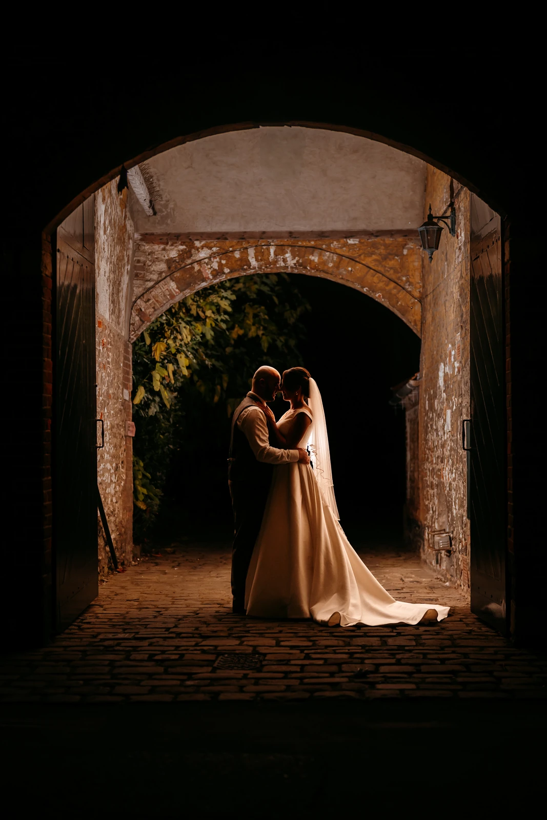 couple under arch night photography specialist lighting wedding
